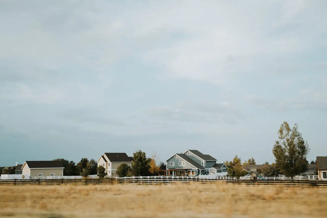 Acreage homes behind a rail fence on the Colorado plains