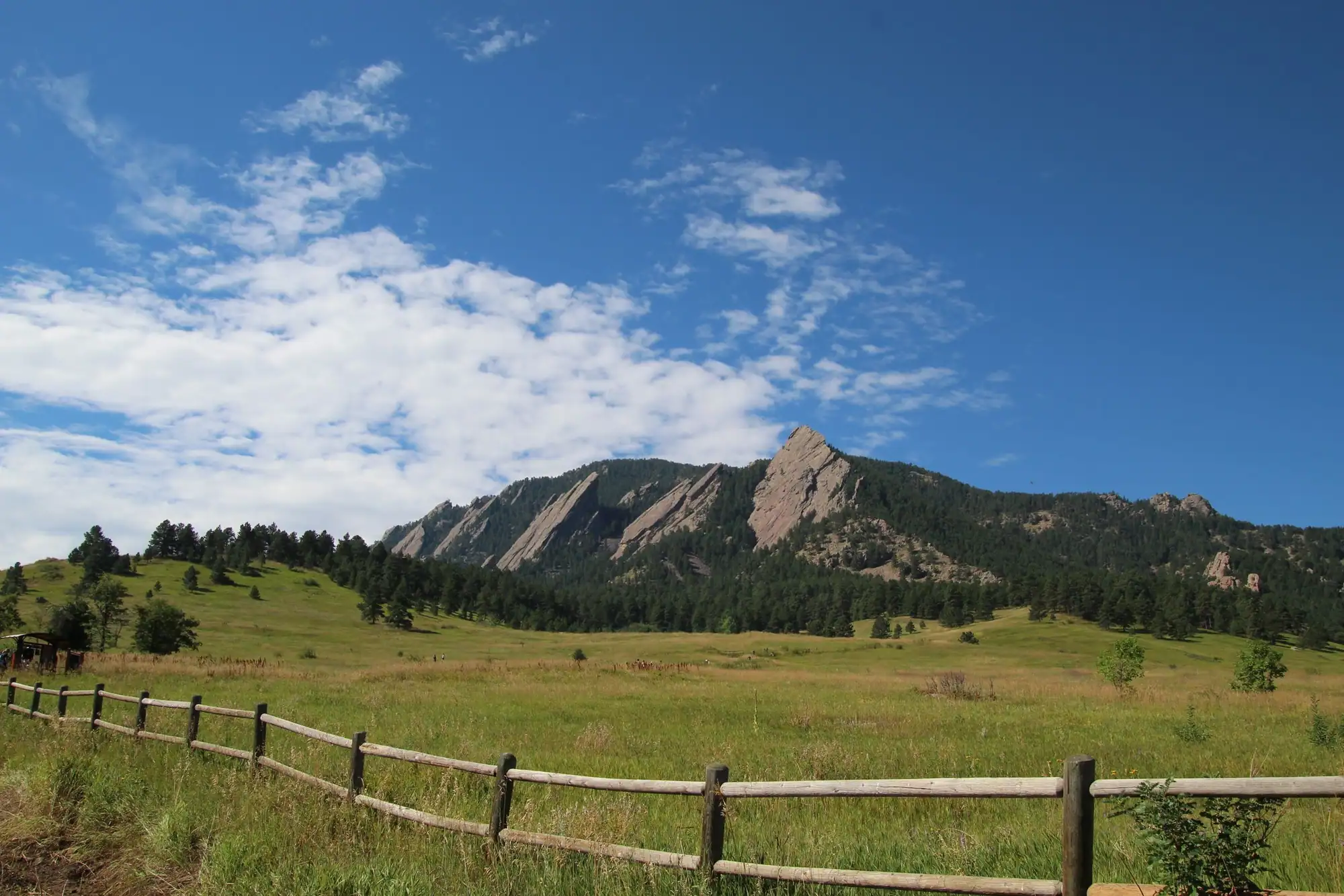 Green grassland below the Flatirons on Colorado’s Front Range