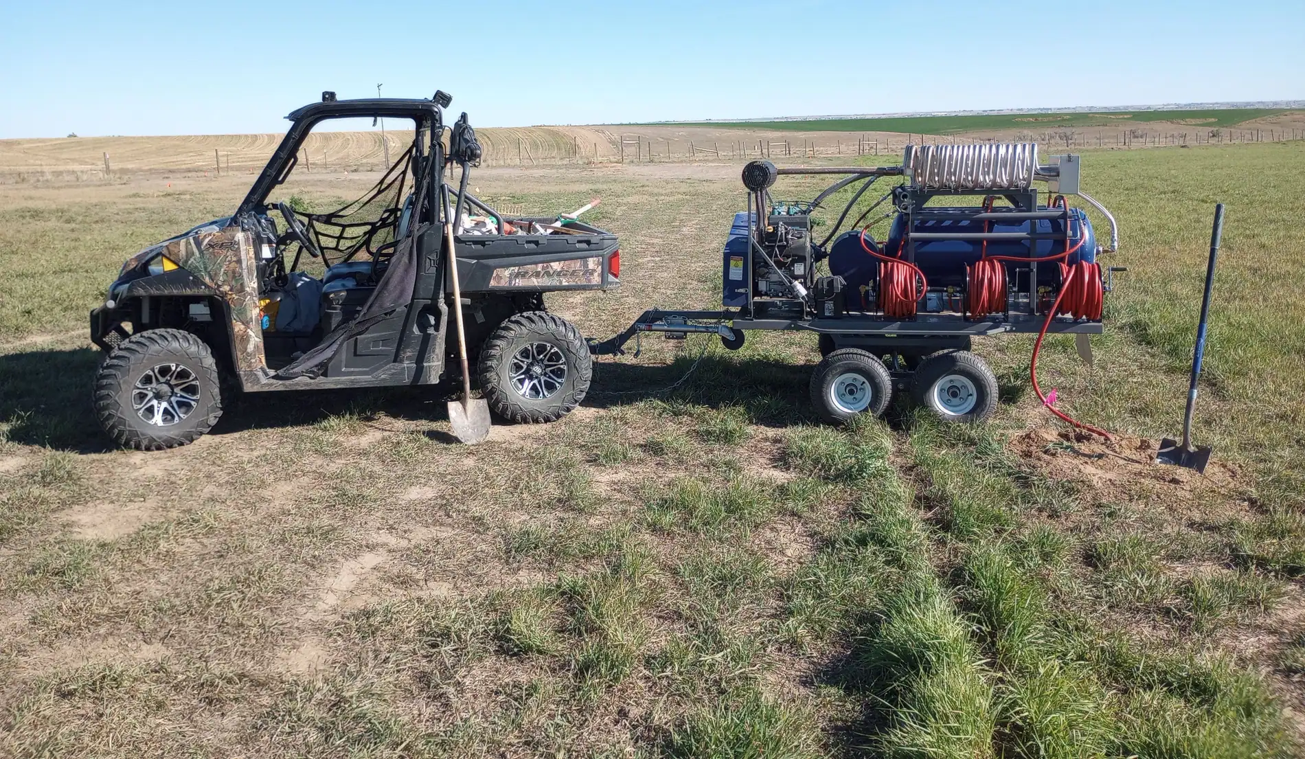 The Rodent Ranger’s UTV and PERC trailer out on open pasture